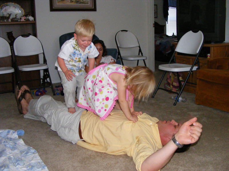 Ali and Micha jumping on Dad